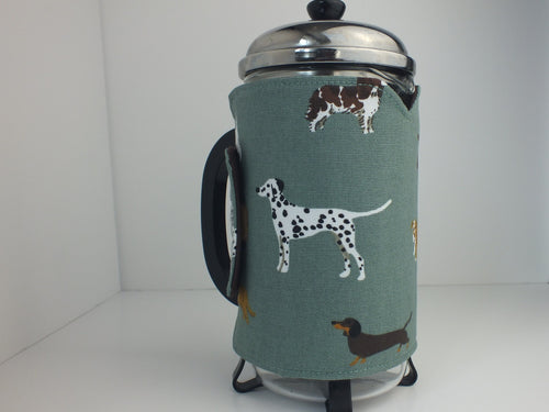 Wrap around French Press/Cafetiere cosy. Thermal lined to keep coffee warmer for longer. Sage green background with cute dog print of different breeds. Closes with hook and loop tape.